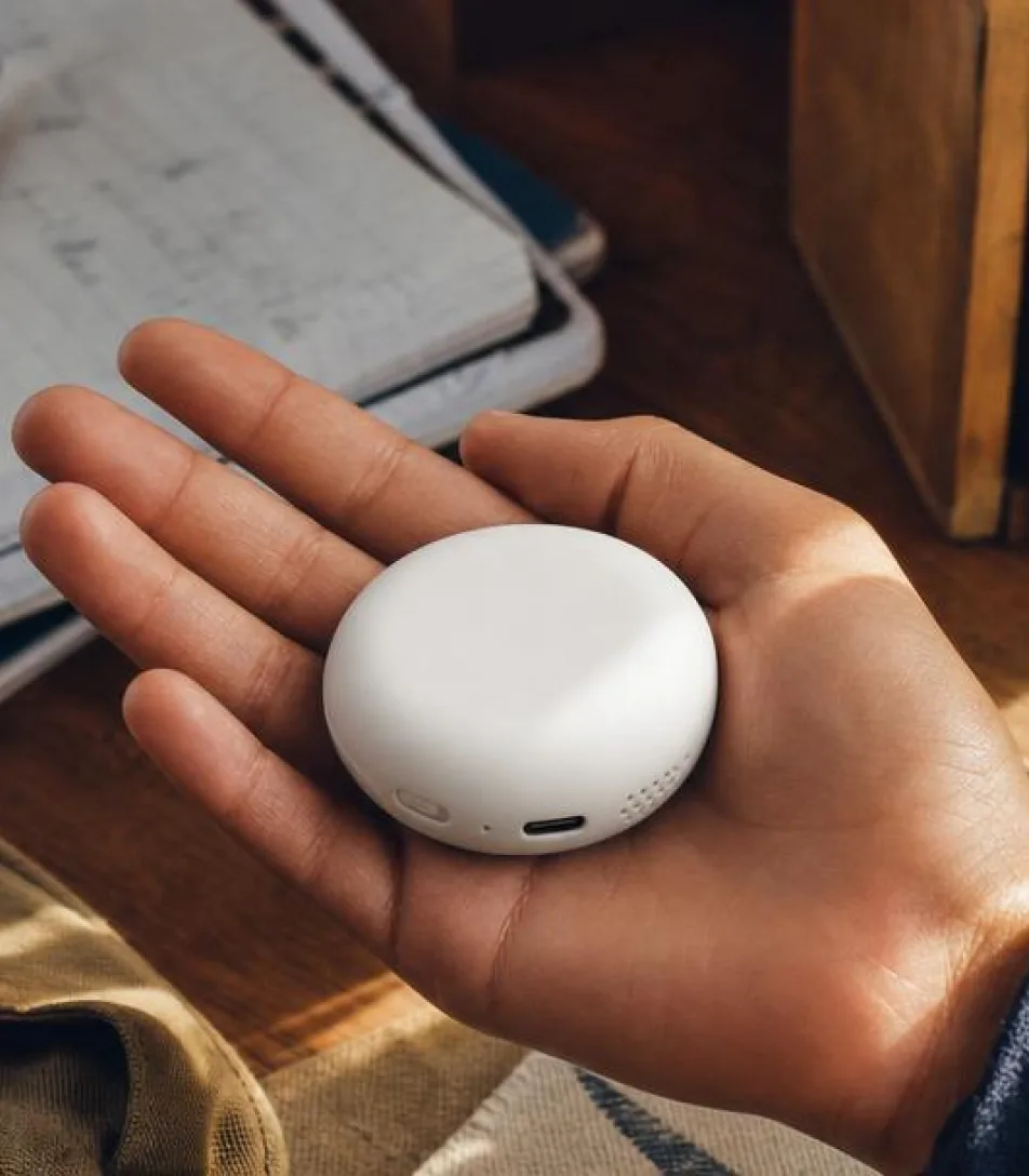 Device-in-hand product close-up.